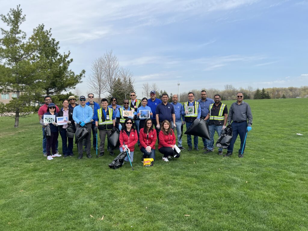 Employees cleaning up trash at a park for Earth Day